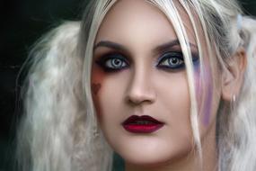 Portrait of a woman with colorful make-up and hair in style of Harley Quinn