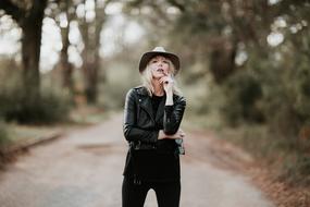 girl in black clothes in the forest on a blurred background