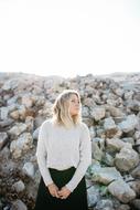woman near a pile of stone outdoors