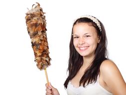 Smiling girl, holding colorful brush cleaner in the hand, at white background