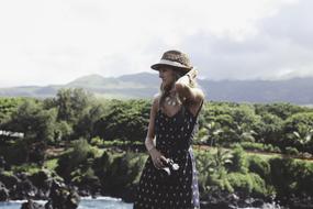 Fashion Girl with camera at scenic landscape