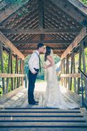 kissing wedding couple under the roof