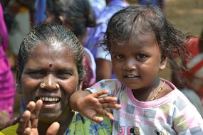 photo of indian woman with a baby in her arms