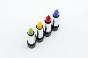 rainbow lipsticks on white background