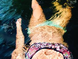swimming woman in transparent sea water