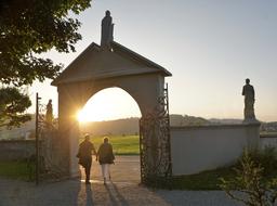 couple of people at the cemetery gate