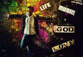 man posing on the street wall with street art