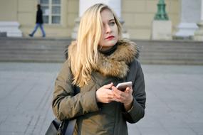 portrait of the Young blonde woman with the phone