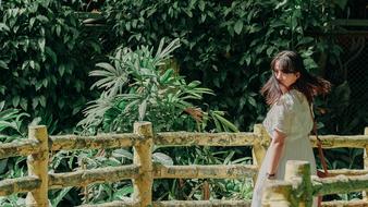 Portrait of the beautiful girl near the fence