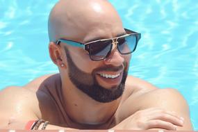 Man with the sunglasses in the swimming pool