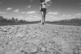 walking woman on Rocks on Dirt Road