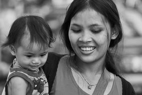 black and white portrait of mom with baby in cambodia