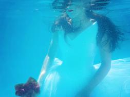 girl in a wedding dress underwater