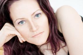 photo of a girl with burgundy hair and blue eyes