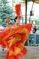 dancing girl in an orange yellow dress