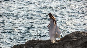 bride on a rock against the background of the sea