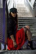 Girl in cap, posing near the stairs in shadows and light