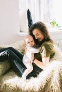 mom with small child in a fluffy chair