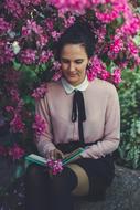 Girl with book in garden