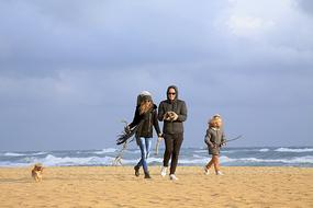 Family and dog in sand