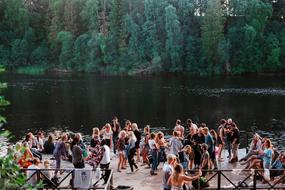 crowd of people at a party by the river