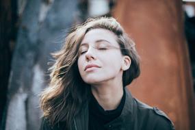 girl with closed eyes outdoors