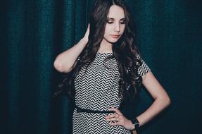 brunette in black and white dress with zigzag