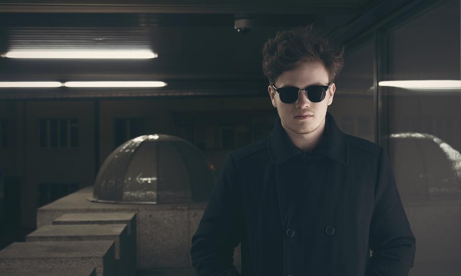 young man in sunglasses and black Coat