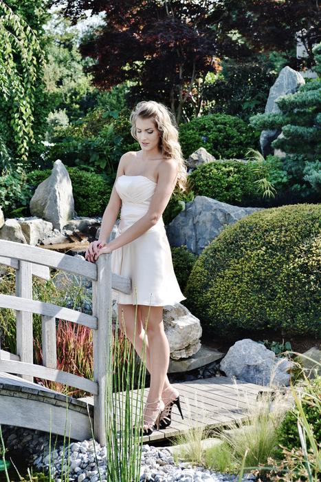 beautiful young girl posing at bridge in park