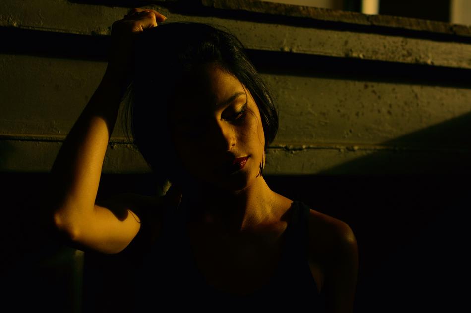 Portrait of the beautiful girl, with closed eyes, in light, among the darkness