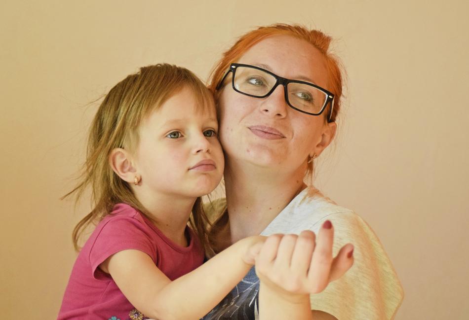 Portrait of the mother, with the glasses and daughter, holding hands together