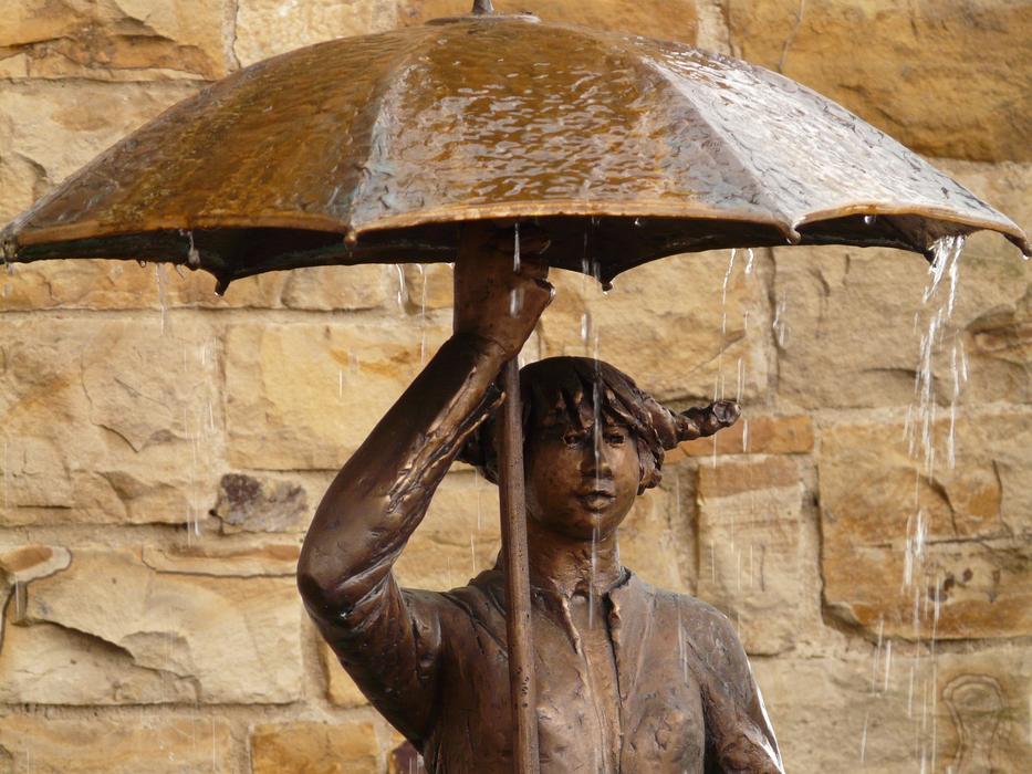 bronze figure with umbrella
