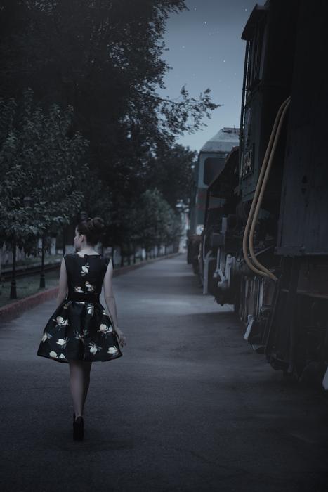 girl in dress walking at dusk