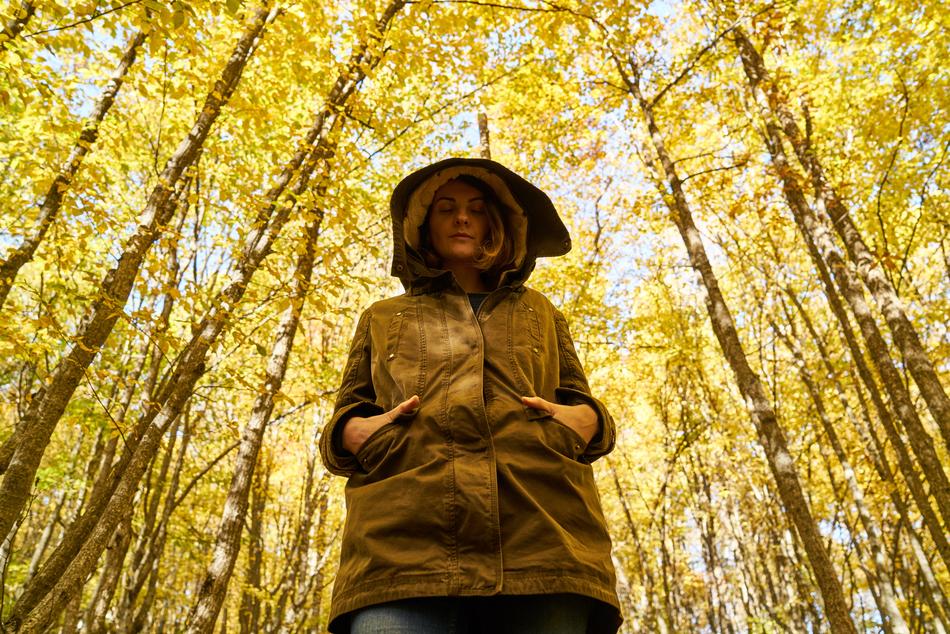 Depressed woman in forest at fall