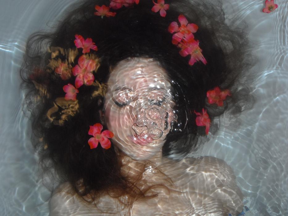 woman underwater with flowers