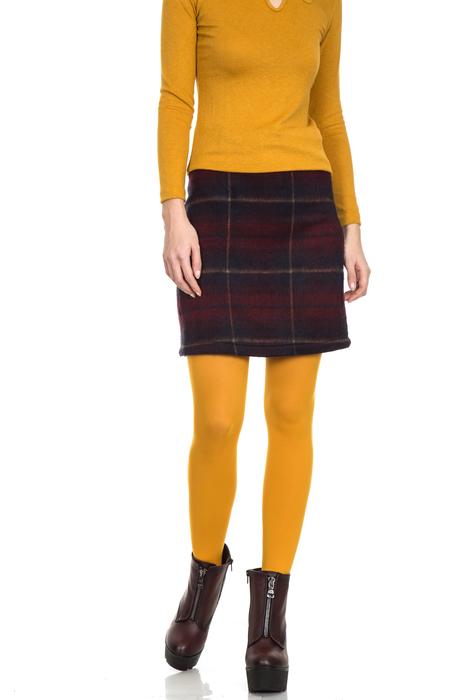 girl in yellow in a fashionable plaid skirt