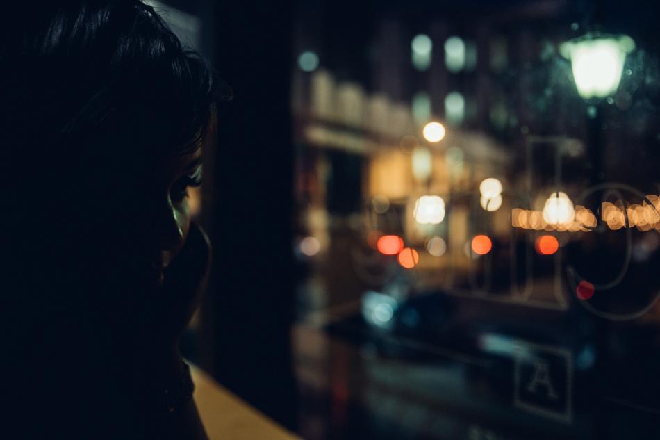 Silhouette of the person, in the city with colorful lights, at the night