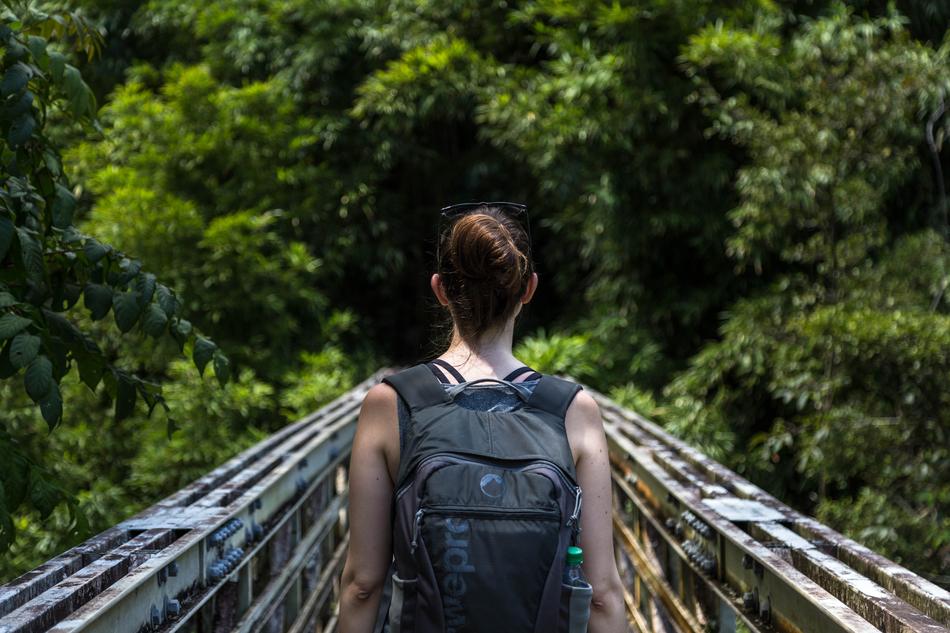 girl with black backpack on the bridge