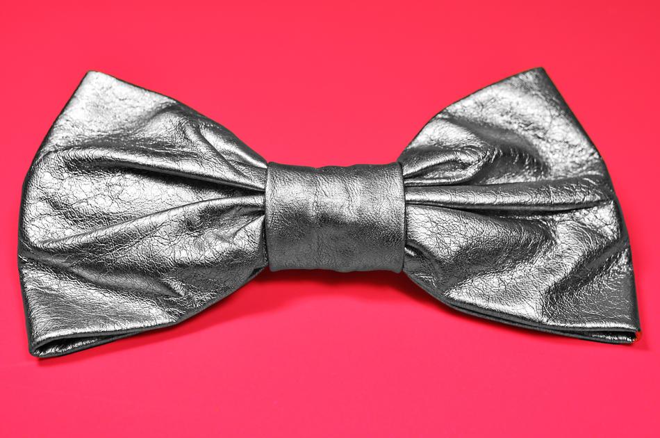 Close-up of the shiny, silver box on the pink surface