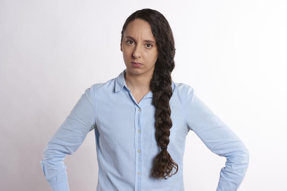 Skeptical young Woman with long braid