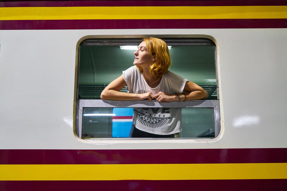 blonde in the window of a vintage train