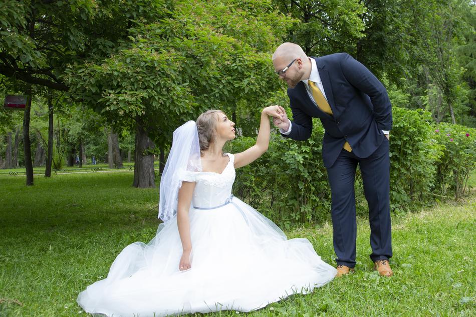 Bride and groom in costumes, among the beautiful plants