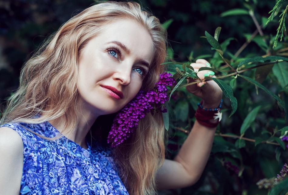 portrait of a girl near a lilac bush