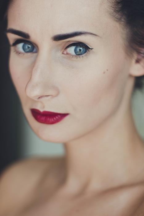 Portrait of the woman with make-up and blue eyes, and bare chest