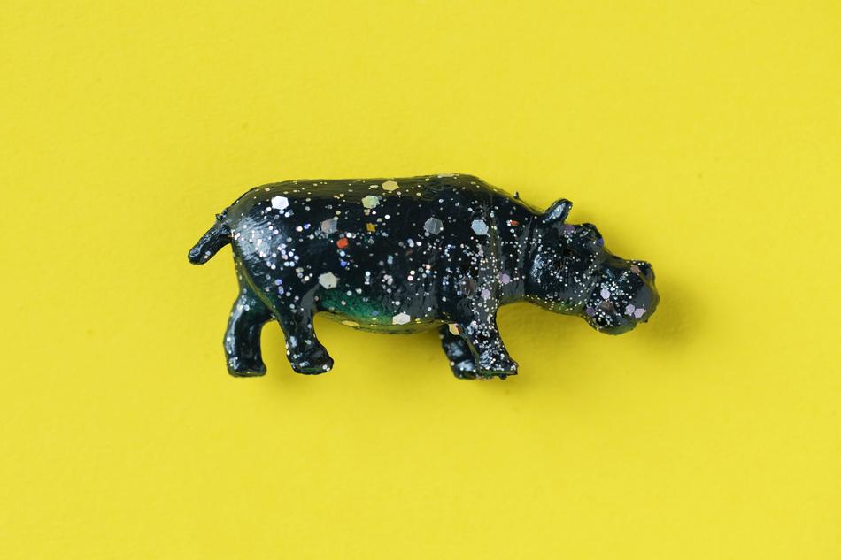 figurine of a hippopotamus on a yellow background