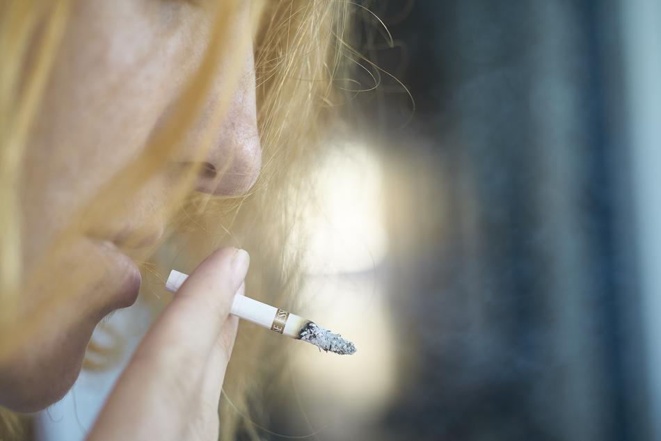 blonde with a cigarette on a blurred background