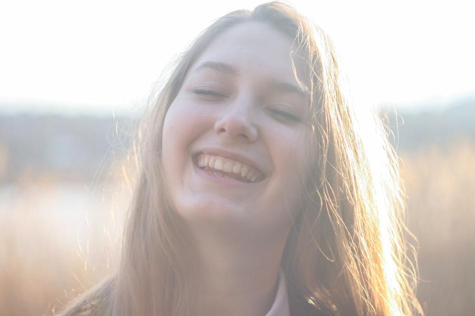 portrait of a happy girl in sunbeams on a blurred background