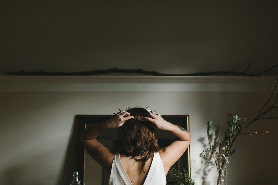 Back view of the girl with colorful and beautiful floral wreath on the head, in the building