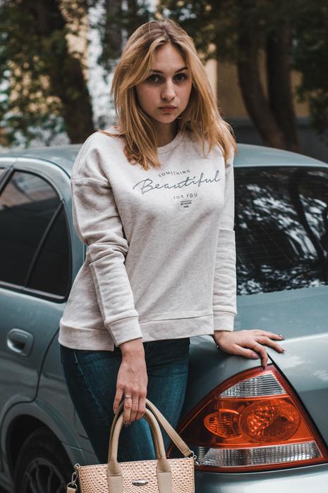 girl standing near the car on the street