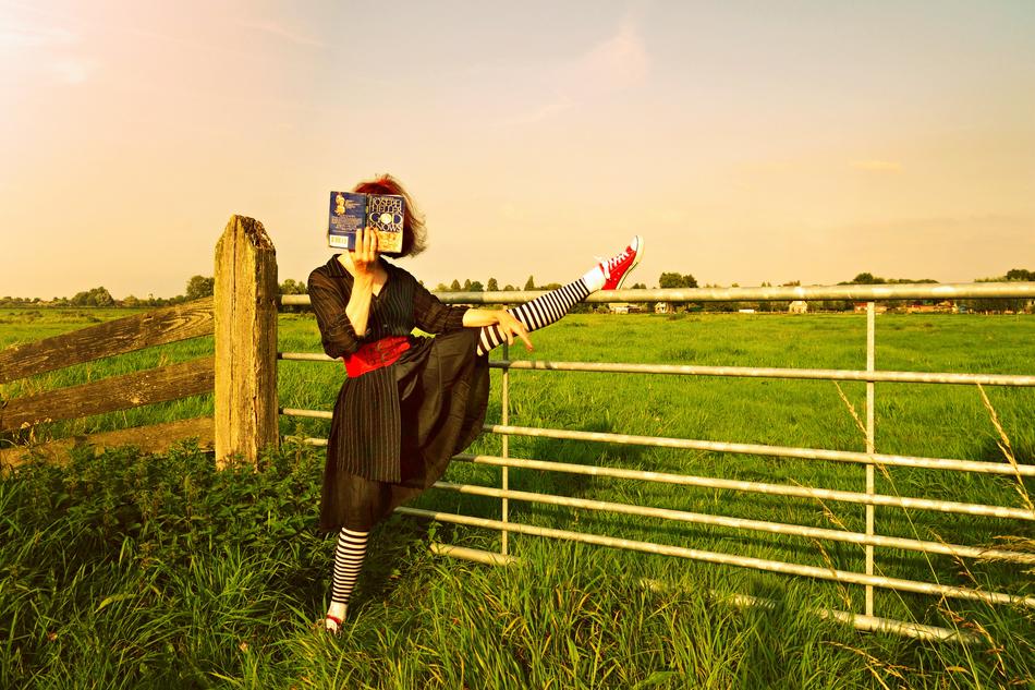 stylish model with a book in striped pantyhose
